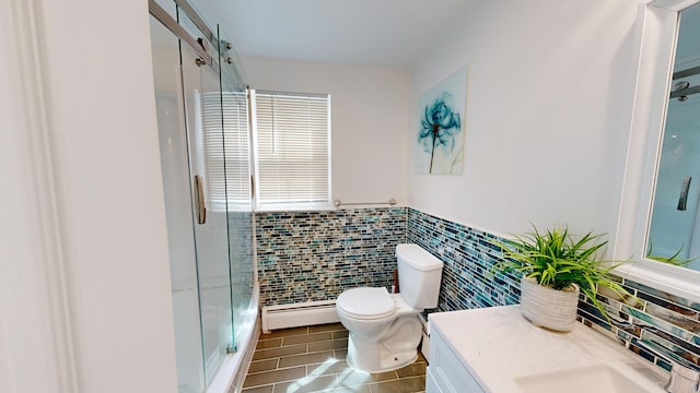 bathroom with tile patterned flooring, toilet, tile walls, a baseboard radiator, and a shower with door