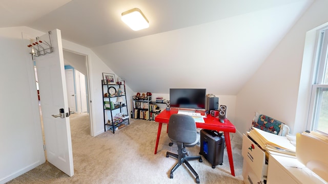carpeted office featuring vaulted ceiling
