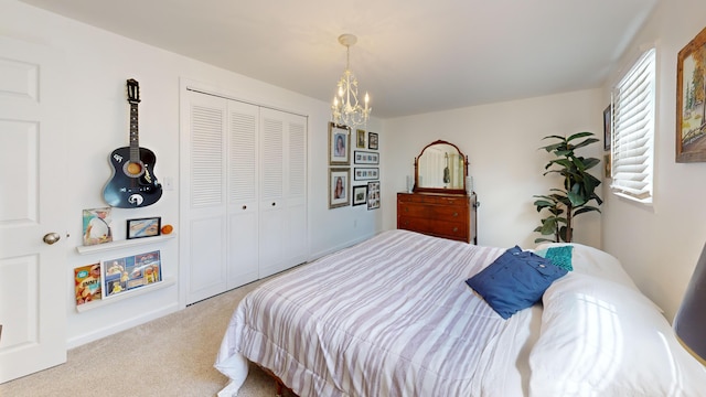 carpeted bedroom with a closet and a notable chandelier