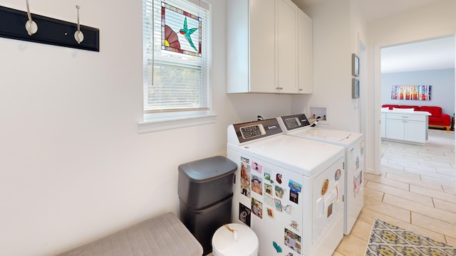 washroom featuring washing machine and dryer and cabinet space