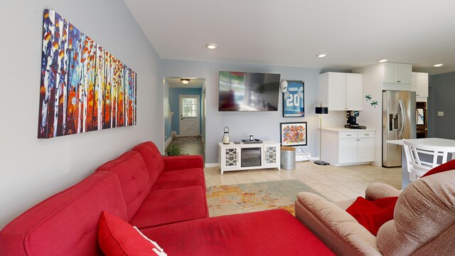 living room with light tile patterned floors, baseboards, and recessed lighting