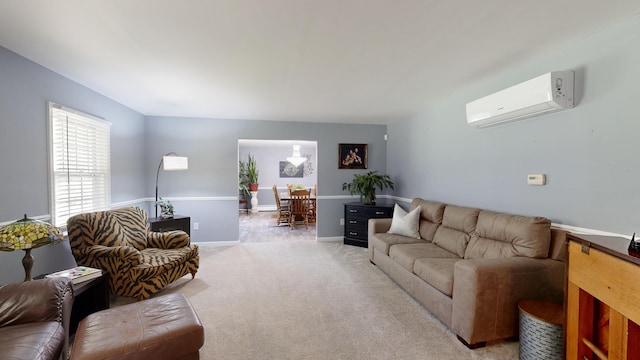 living room with an AC wall unit, baseboards, and light colored carpet