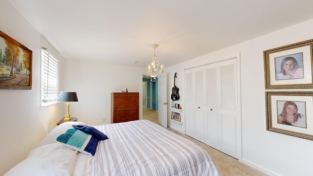 bedroom featuring carpet floors, baseboards, a closet, and a notable chandelier