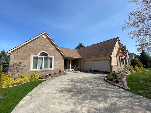 ranch-style house with an attached garage, concrete driveway, a front yard, and brick siding