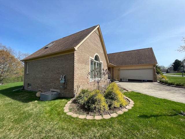 view of home's exterior with a garage, concrete driveway, a yard, and brick siding