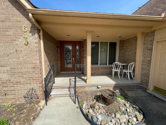 entrance to property featuring brick siding