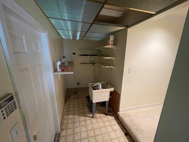 laundry area featuring baseboards, laundry area, and tile patterned floors