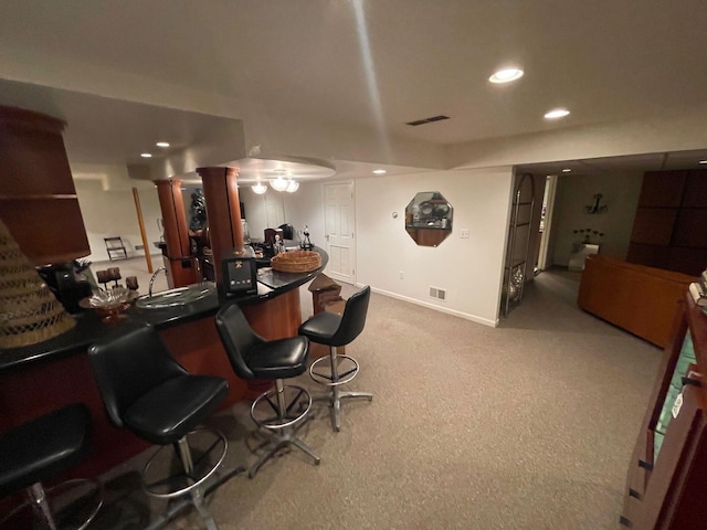 bar featuring visible vents, decorative columns, baseboards, recessed lighting, and carpet flooring