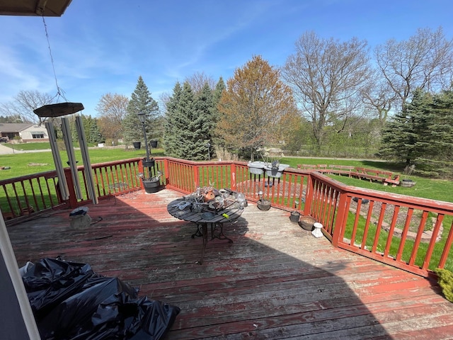 wooden deck featuring a yard