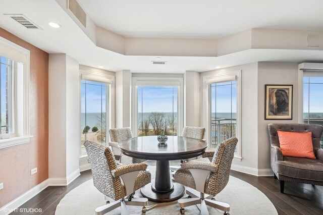 dining room with baseboards, dark wood finished floors, and visible vents