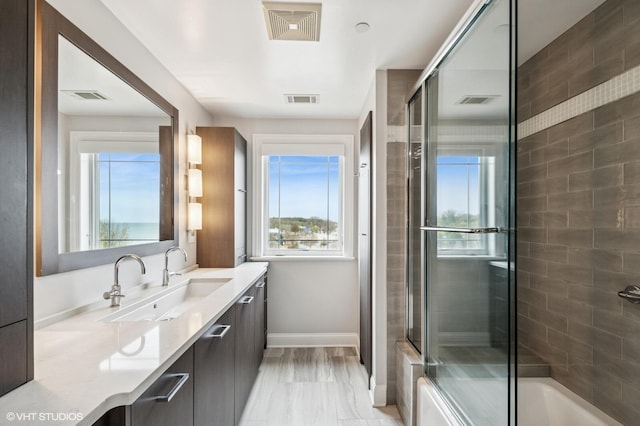 bathroom with visible vents, bath / shower combo with glass door, and baseboards