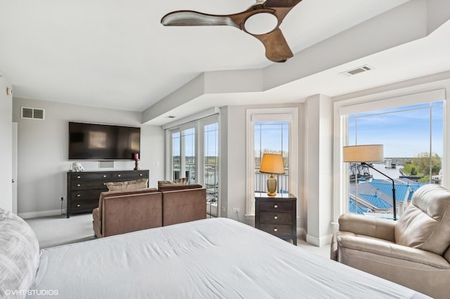carpeted bedroom featuring baseboards, visible vents, access to exterior, and ceiling fan