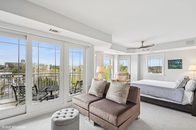 bedroom with carpet floors, visible vents, and access to exterior