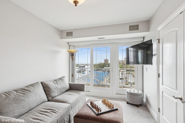 carpeted living area featuring visible vents