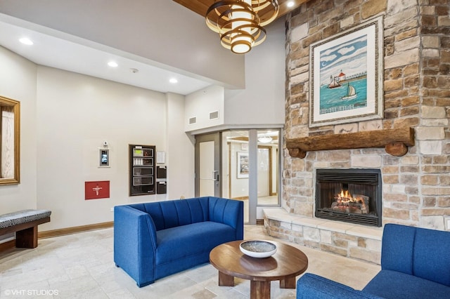 living room featuring baseboards, a fireplace, recessed lighting, and visible vents