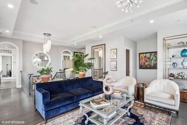 living area featuring wood finished floors, a chandelier, ornamental molding, a tray ceiling, and recessed lighting