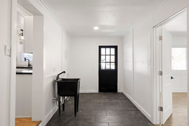 foyer entrance featuring ornamental molding