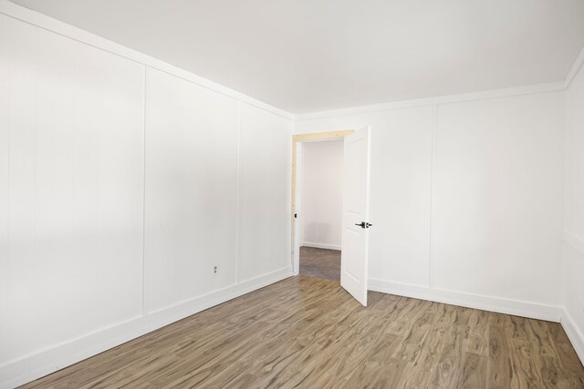 unfurnished room featuring light wood-style floors and baseboards