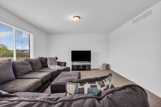 carpeted living area featuring visible vents