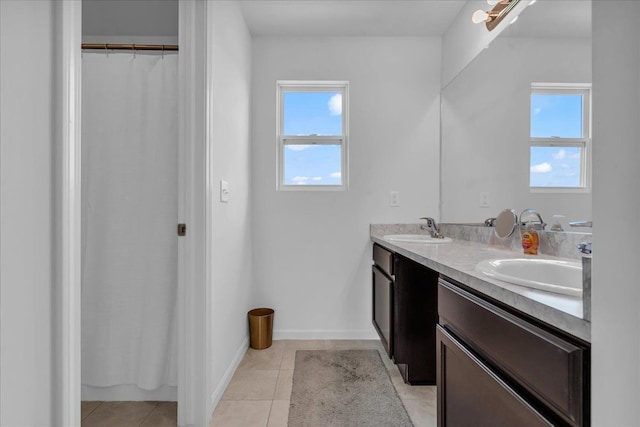 full bathroom featuring a sink, a healthy amount of sunlight, and tile patterned floors