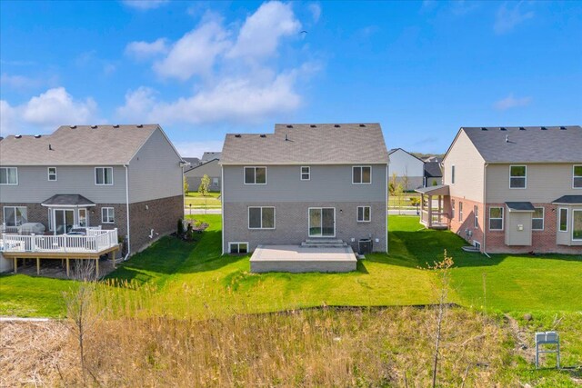 rear view of house with a lawn, a patio area, a residential view, and a deck