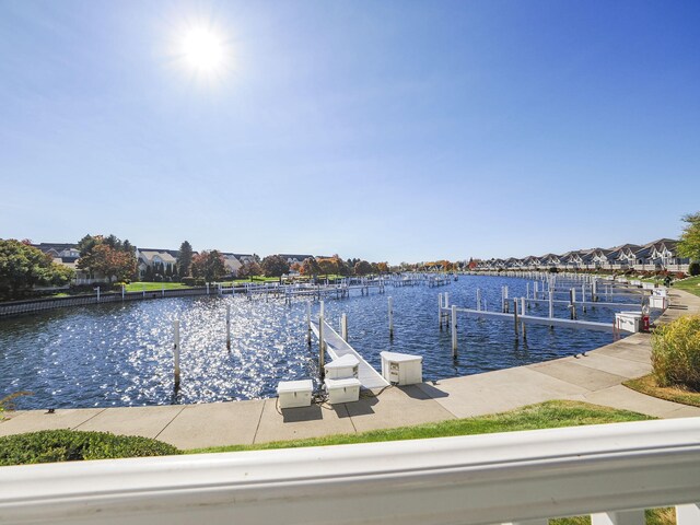 dock area featuring boat lift and a water view