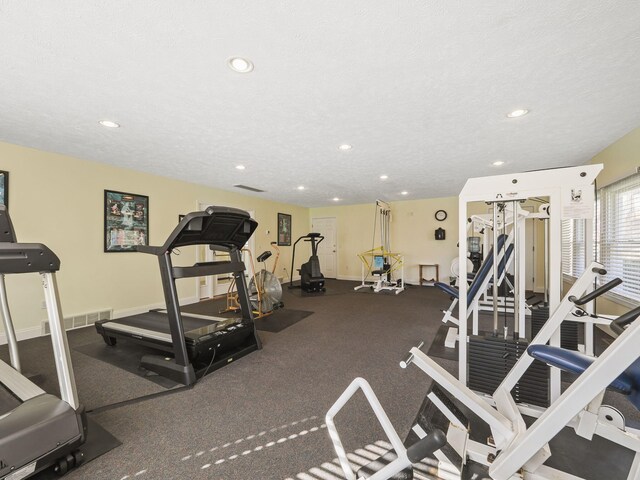 exercise room featuring baseboards, recessed lighting, and visible vents