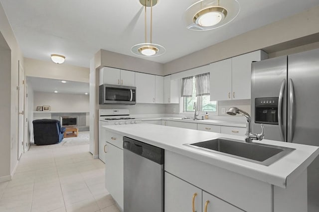 kitchen featuring a sink, light countertops, white cabinets, and stainless steel appliances