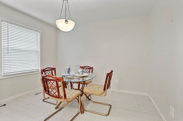 dining room featuring baseboards and a healthy amount of sunlight
