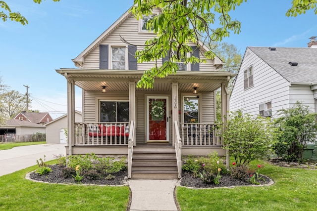 bungalow-style house featuring a porch and a front lawn