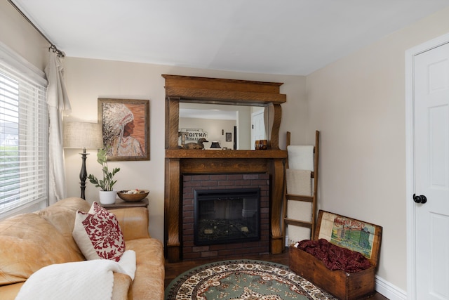 living room with a brick fireplace