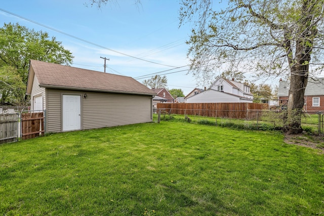 view of yard with an outdoor structure and a fenced backyard