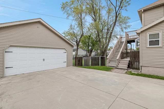 detached garage featuring fence