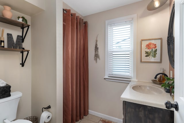 full bathroom with vanity, baseboards, tile patterned flooring, and a healthy amount of sunlight