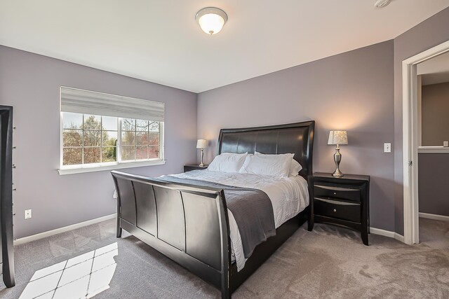 carpeted bedroom featuring baseboards