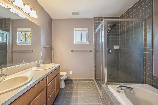 full bath featuring a garden tub, a sink, tile patterned flooring, and a stall shower