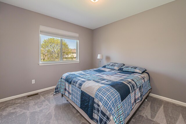bedroom with baseboards, carpet, and visible vents