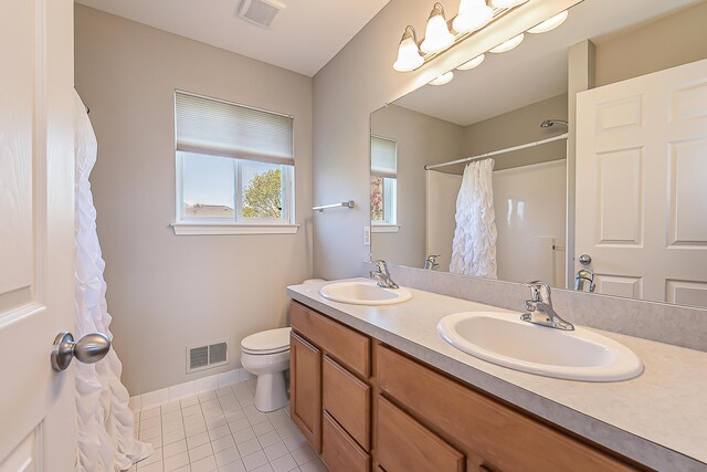 bathroom featuring visible vents, a sink, and toilet