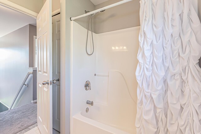 full bath with tile patterned floors and shower / tub combo with curtain