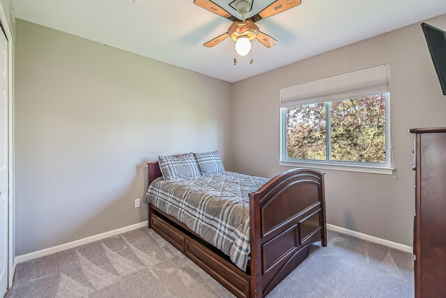 bedroom featuring baseboards, ceiling fan, and carpet flooring