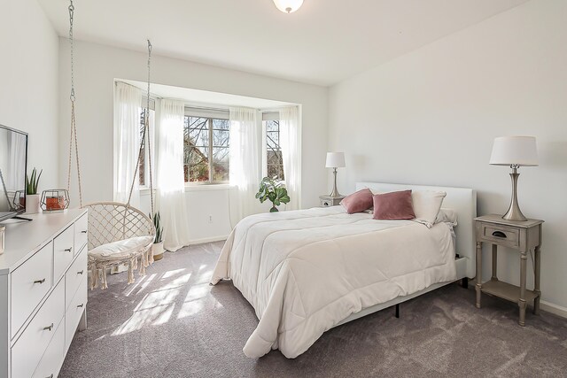 bedroom featuring carpet floors and baseboards