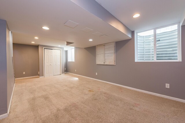 basement with recessed lighting, baseboards, and light colored carpet