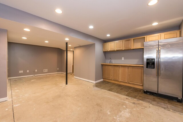 kitchen with stainless steel refrigerator with ice dispenser, baseboards, and recessed lighting