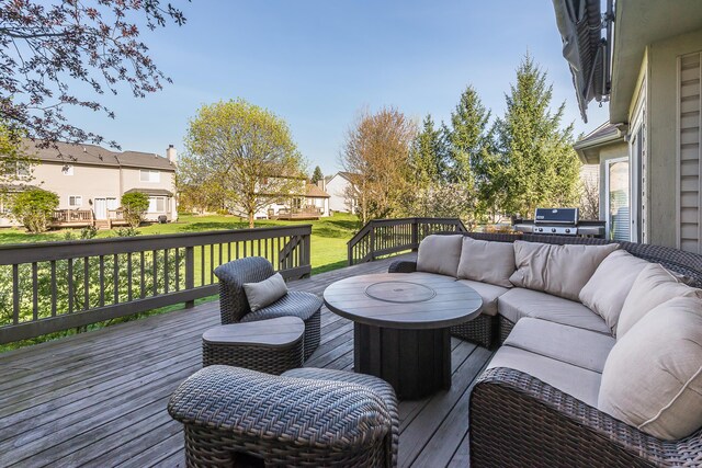 wooden deck with a residential view, a yard, and an outdoor living space