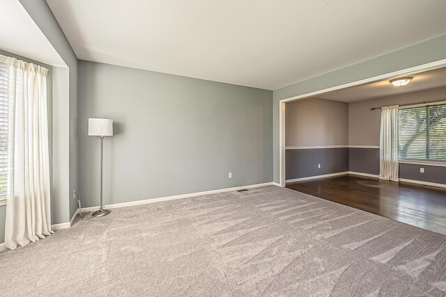 carpeted spare room with baseboards