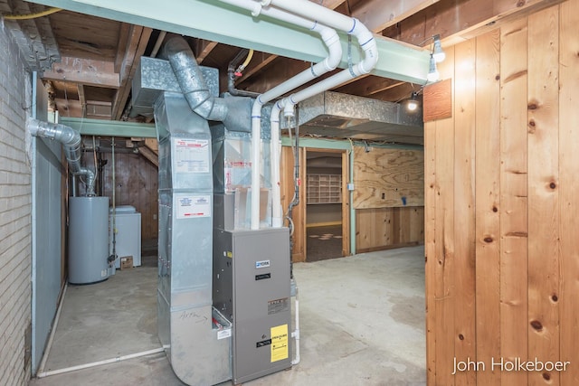 utilities featuring heating unit, gas water heater, and washer / clothes dryer