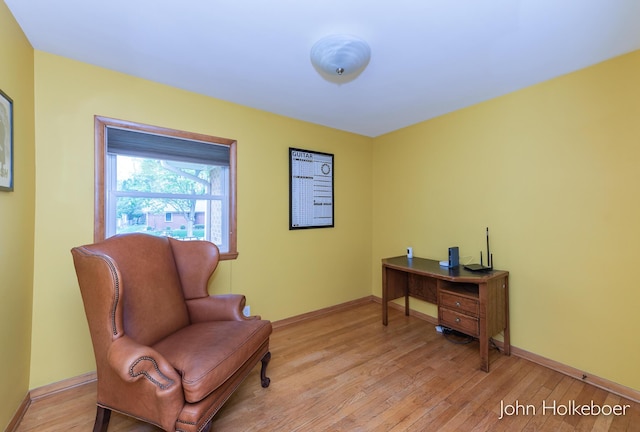 sitting room featuring light wood-type flooring and baseboards