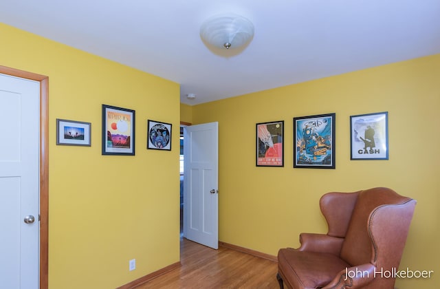 living area featuring baseboards and wood finished floors