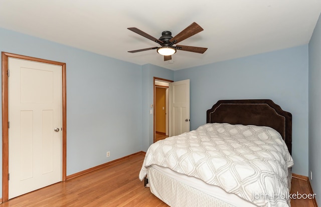 bedroom featuring light wood-type flooring, a ceiling fan, and baseboards