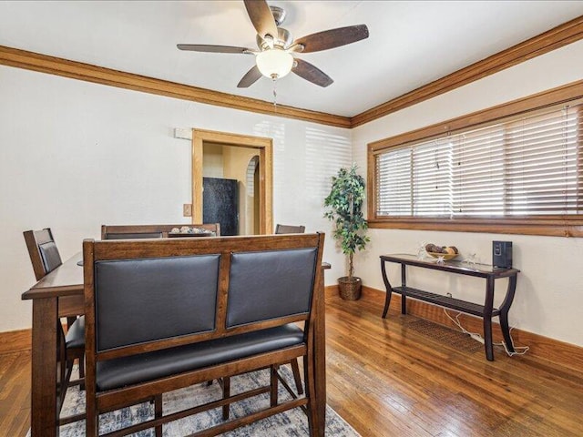 dining space with crown molding, ceiling fan, and wood finished floors